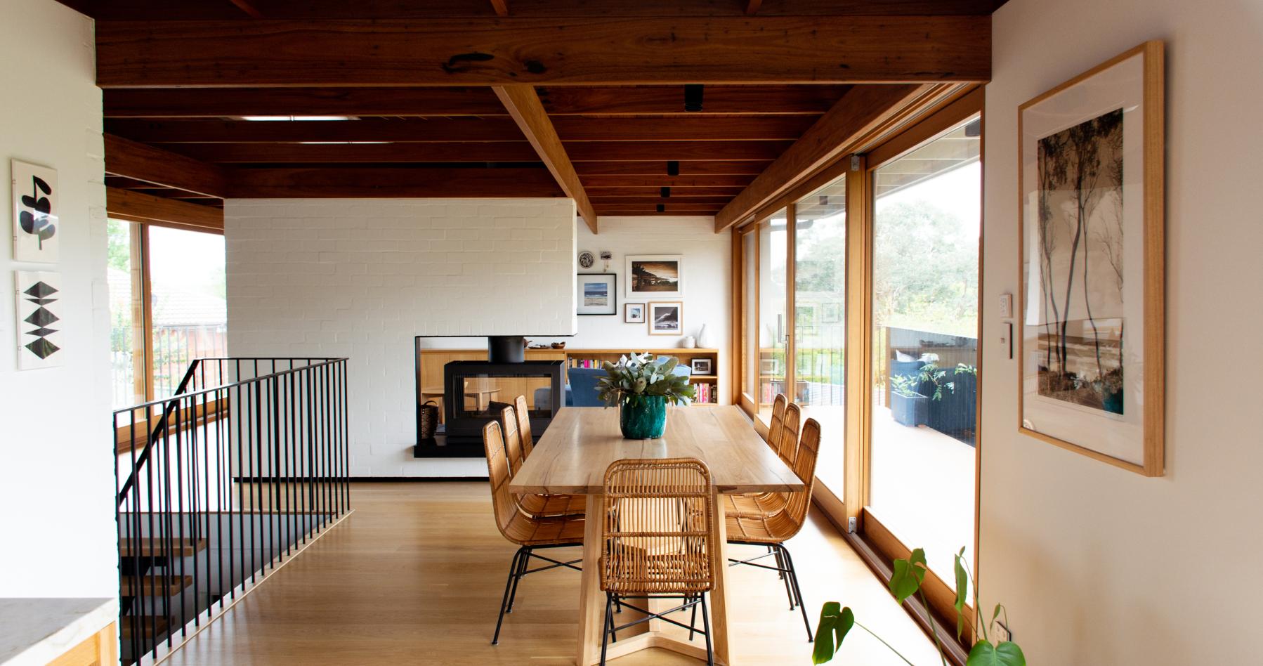 exposed timber ceiling dinning room with large windows