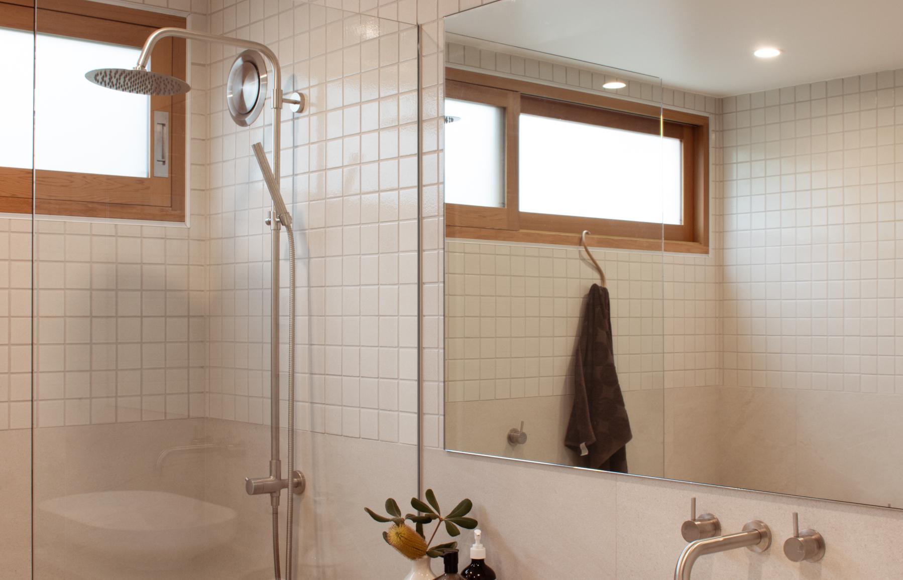 Bathroom, with light tiles, and timber vanity 
