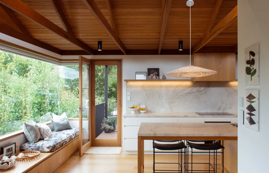 Kitchen with timber celling and glass corner window, with bench seat
