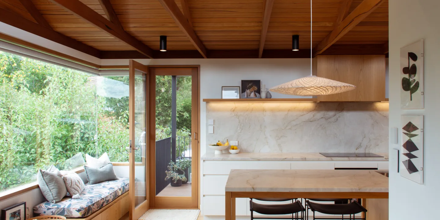 Kitchen with timber celling and glass corner window, with bench seat